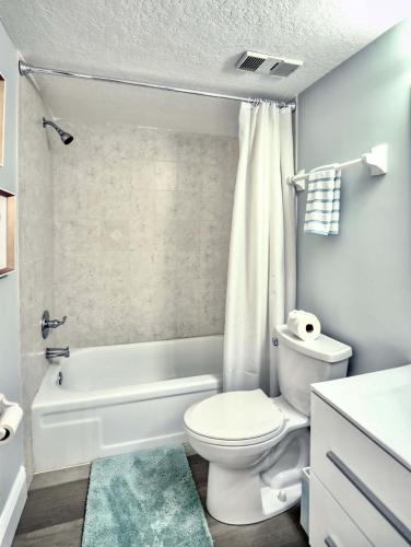 a bathroom with a toilet and a tub and a sink at Pier Point South Ocean View Condo C-34 in St. Augustine