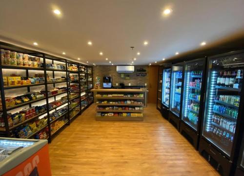 a grocery store aisle with shelves of food and drinks at S4 Hotel in Brasilia