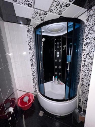 a bathroom with a tub and a sink in a room at Ramal Apartment in Baku