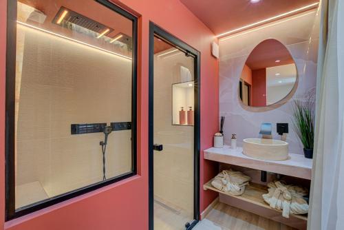 a bathroom with a shower and a sink and a mirror at Serenity Suite in Bourgoin