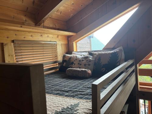 a small room with a couch and a window at Classy Bear Cabin in Gatlinburg