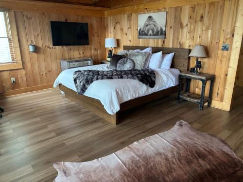 a bedroom with a bed and a television in it at Classy Bear Cabin in Gatlinburg
