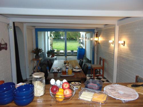 a kitchen with a table with bowls of food on it at Dutchies-dk in Væggerløse