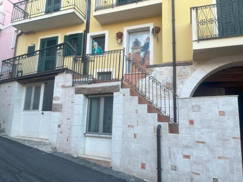 a building with balconies and people in the window at Gafo da Longa in Satriano