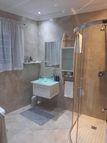 a bathroom with a sink and a shower at Simply The Choice Manor in Panorama
