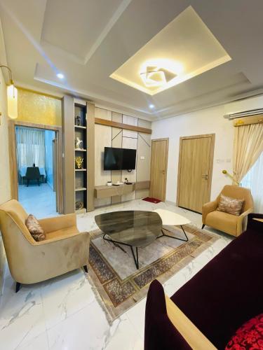 a living room with a couch and a table at Viklis Luxury Apartments in Port Harcourt