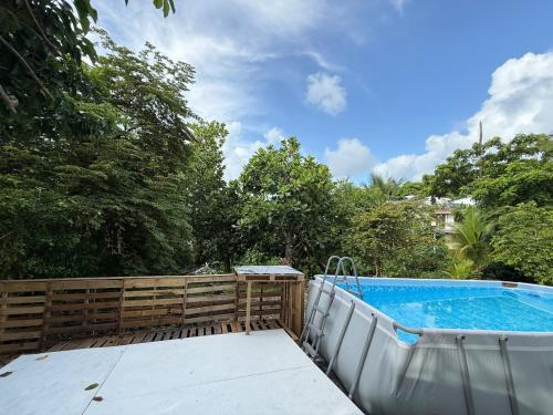 a swimming pool next to a wooden fence at Casa taj beach house in La Loma