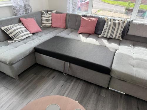 a gray couch with pillows on it in a living room at Taunton Retreat in Wilton