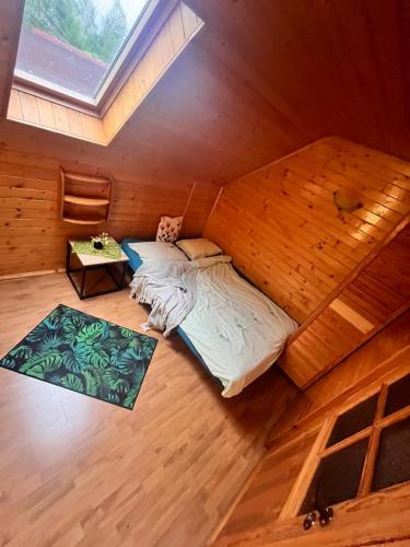 an overhead view of a bed in a room at Słoneczny domek in Brenna
