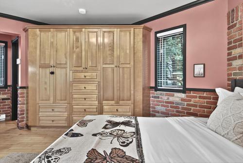 a bedroom with a bed and a brick wall at Domaine Rivière Sacacomie in Saint-Alexis-des-Monts