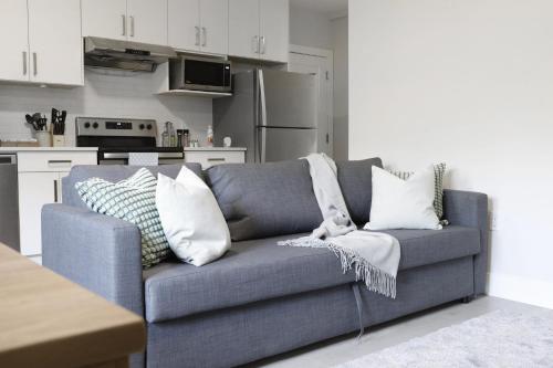 a living room with a blue couch in a kitchen at Cozy 2BR for Family & Private Parking & Near Mall in Langley