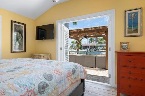 una camera con letto e porta che conduce alla piscina di Waterfront Paradise a Holmes Beach