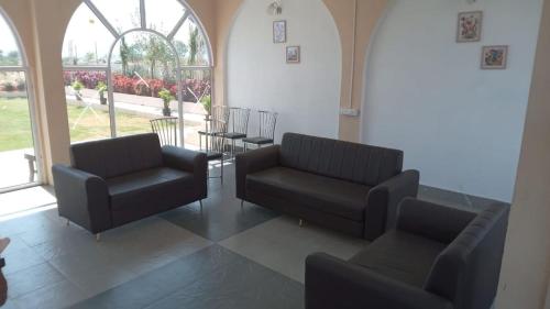 a waiting room with two chairs and a table at The Sol Street Villa in Nashik
