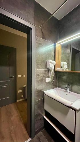 a bathroom with a sink and a mirror at GRAND JNK Boutique Hotel in Kukës