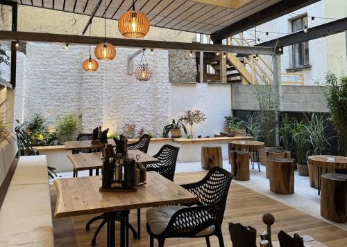 a restaurant with wooden tables and chairs and lights at Pension SKLEP in Prague