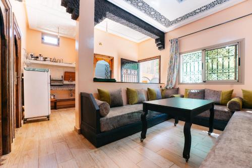 a living room with a couch and a table at The best apartments of Ourika valley in Amlouggui