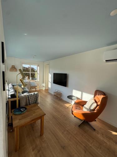 a living room with a couch and a table at Smukt sommerhus nær Ribe C inkl rengøring in Ribe