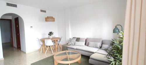 a living room with a couch and a table at Paraíso Soleado Estepona Costa Del Sol in Estepona