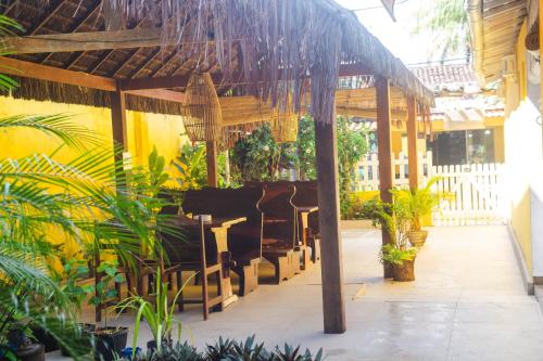 a pavilion with benches and plants in a building at POUSADA VELHA BOIPEBA in Ilha de Boipeba