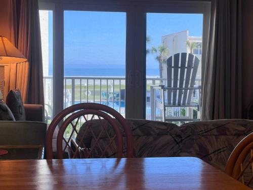 a living room with a couch and a view of the ocean at Relaxing Poolside Ocean View Townhouse Condo C-32 in Saint Augustine Beach