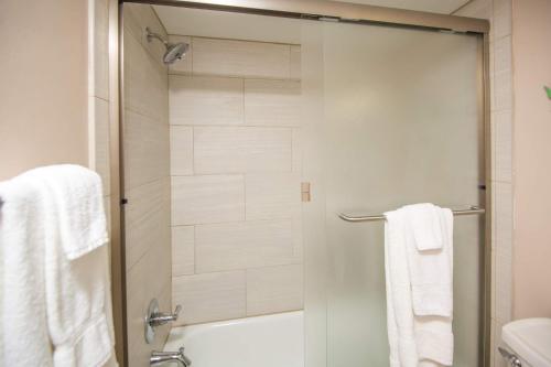 a bathroom with a shower with white towels at Pier Point South Oceanfront Townhouse Condo A-3 in Saint Augustine Beach