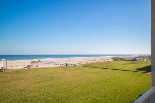 a view of the beach from the balcony of a house at Pier Point South Oceanfront Townhouse Condo A-8 in Saint Augustine Beach