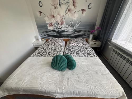 a room with a bed with a bowl of flowers on it at U Małgorzaty in Wojtkowa