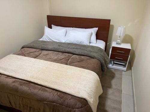 Ένα ή περισσότερα κρεβάτια σε δωμάτιο στο Apartamento en el norte de Quito en La Planada