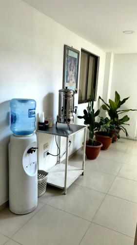 a room with a table with a drink mixer and plants at Hotel Imperio in Ibagué