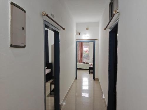 a hallway with two doors leading to a room at Shimray's Minimalist Hostel in Guwahati
