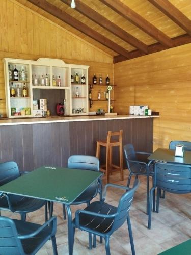 a dining room with tables and chairs and a counter at Casas Rurales Carpe Diem in Yeste