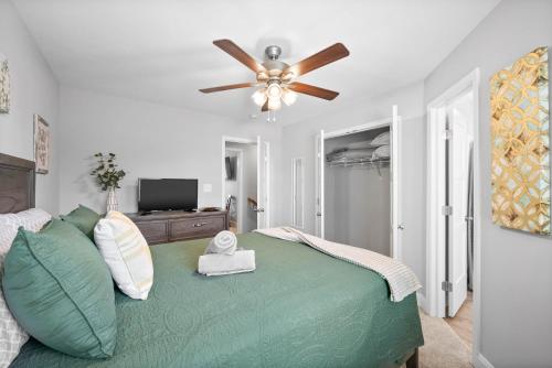 a bedroom with a green bed with a ceiling fan at Unit #606 in Clarksville