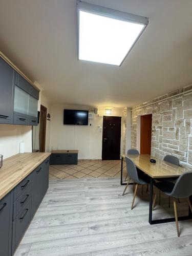 a kitchen with a table and a dining room at 2 rooms apartment Craiova-Craiovita Noua in Craiova