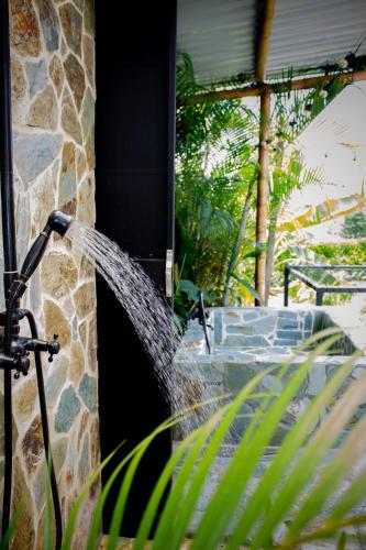 a water hose is coming out of a building at Orange Eco Villas in Quimbaya