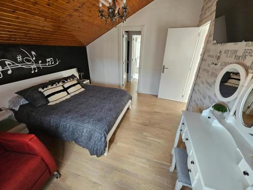 a bedroom with a large bed and a red couch at Casa Rural Alojamientos Marte in Requejada