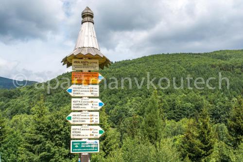 a sign post with many street signs on it at Apartmán v Koutech in Kouty