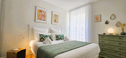 La Girelle - Clim - Balcon - Parking - Mer à 200m في كاري-لو-رويه: غرفة نوم بسرير وخزانة ونافذة