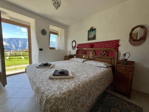 a bedroom with a bed with two towels on it at CASA BERNARD Zortea VANOI cuore verde del Trentino in Canale San Bovo