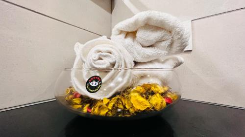 a glass bowl with towels and a towel at Elysium Tower Luxury Serviced Apartments Facing Centaurus Mall Islamabad in Islamabad