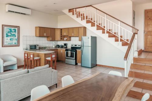 a kitchen and living room with a couch and a table at Villa Sol 96 in Guanacaste