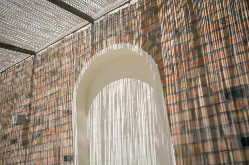 a brick wall with a window in a building at B&B Casa Dei Grilli in Longiano