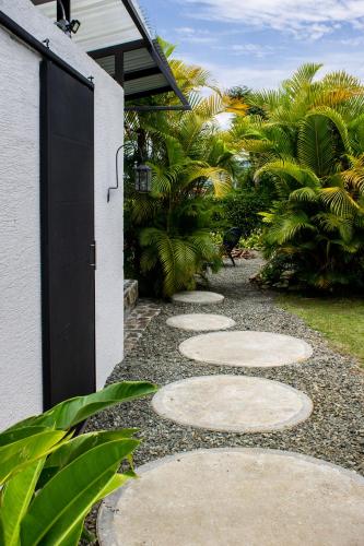 a pathway leading to a house with a black door at Orange Eco Villas in Quimbaya