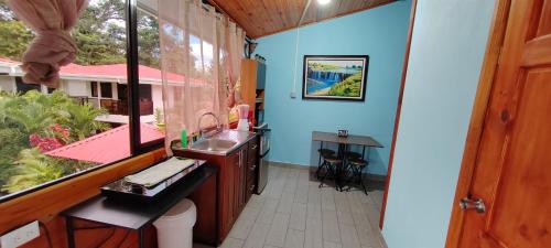 a bathroom with a fish tank in a window at Ballena Rey Hotel in Uvita
