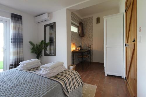 a bedroom with a bed with two pillows on it at Quinta do Canal in Vila Nova de Milfontes