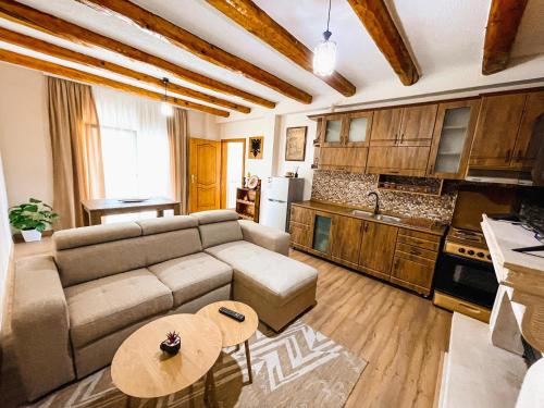 a living room with a couch and a table at Vila Alpini in Razëm