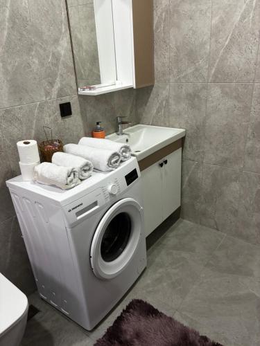 a bathroom with a washing machine and a sink at Medore Hotel & Next to the Beach in Canakkale