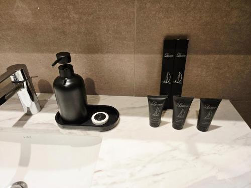 a black soap dispenser sitting on top of a counter at Stunning Burj Khalifa View! Steps to Dubai Mall in Dubai