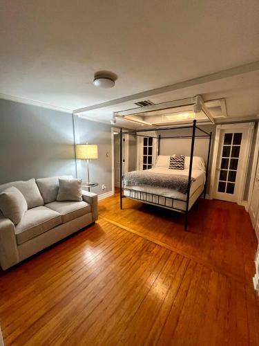 a living room with a bed and a couch at Lafayette House-5 BR Garden Kitchen & Free Parking in Lafayette