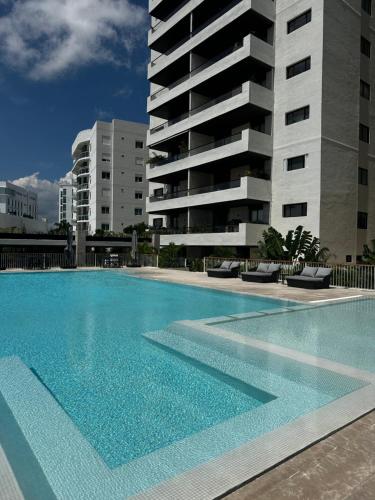 a large swimming pool in front of a building at Vela Towers in Cancún