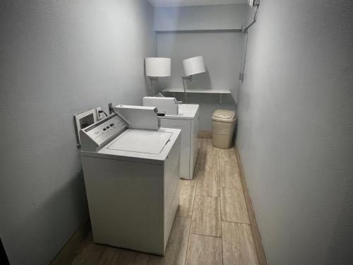 a office with two desks and a toilet in a room at Quality Inn Grand Rapids Near Downtown in Grand Rapids